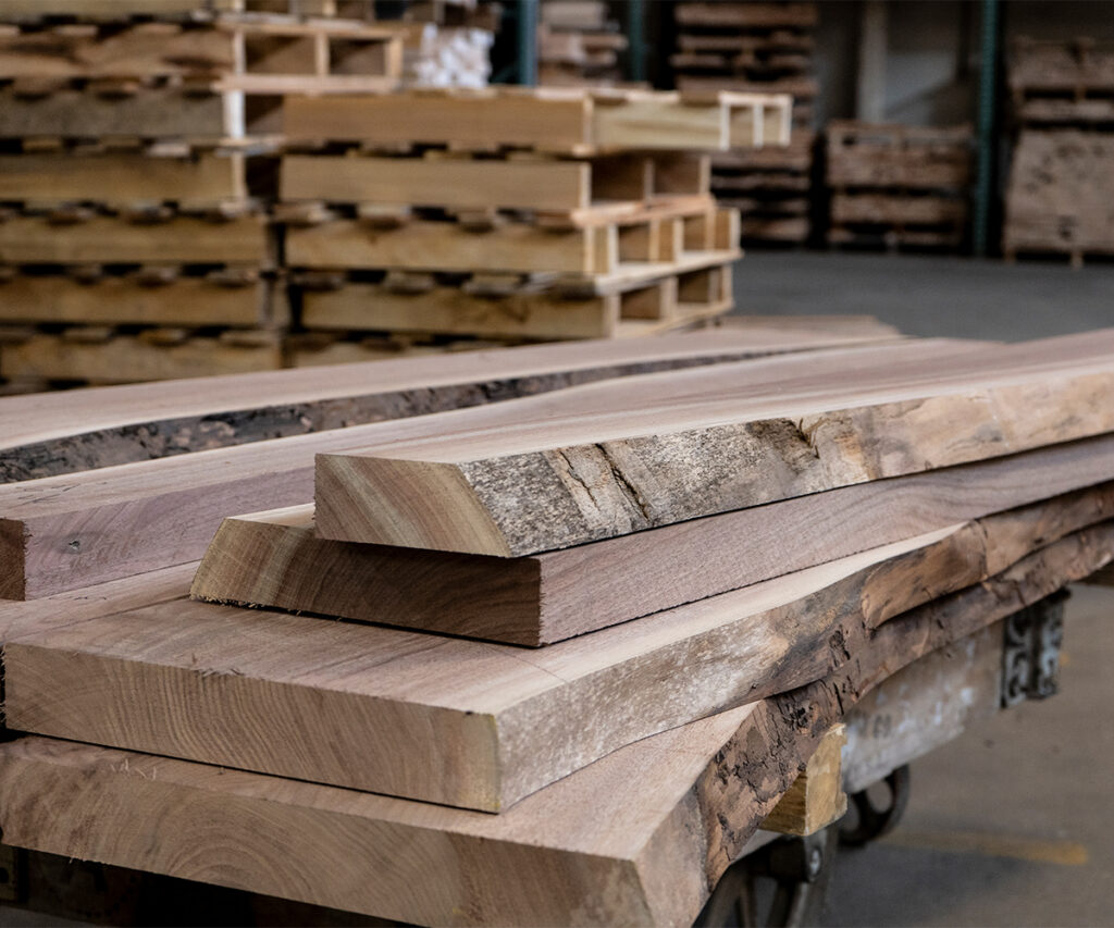 Hardwood boards stacked for Amish furniture lumber selection and grading.